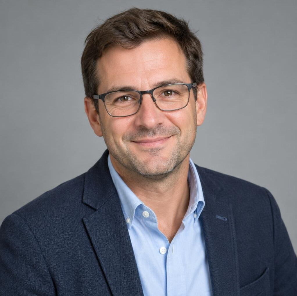 Portrait of a male crisis communication trainer wearing glasses